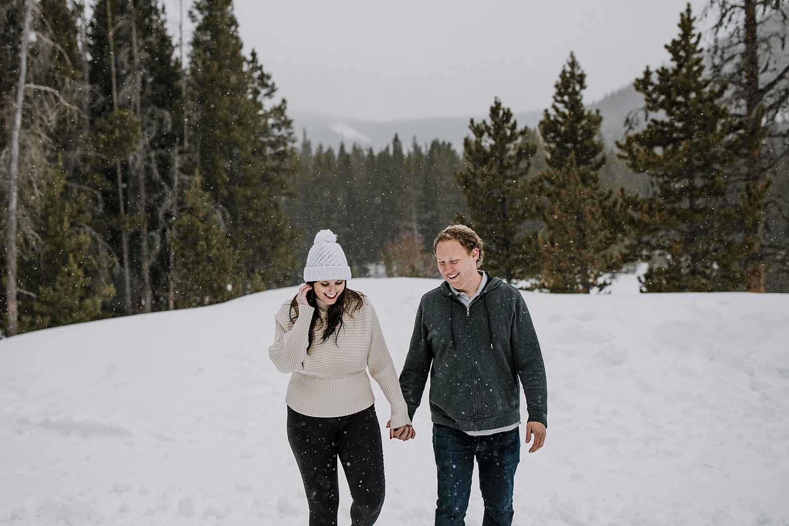 girl getting snow out of her hair, white bridal beanie, summit county elopement in the snow, breckenridge elopement in the snow, colorado elopement in the snow, breckenridge proposal photographer