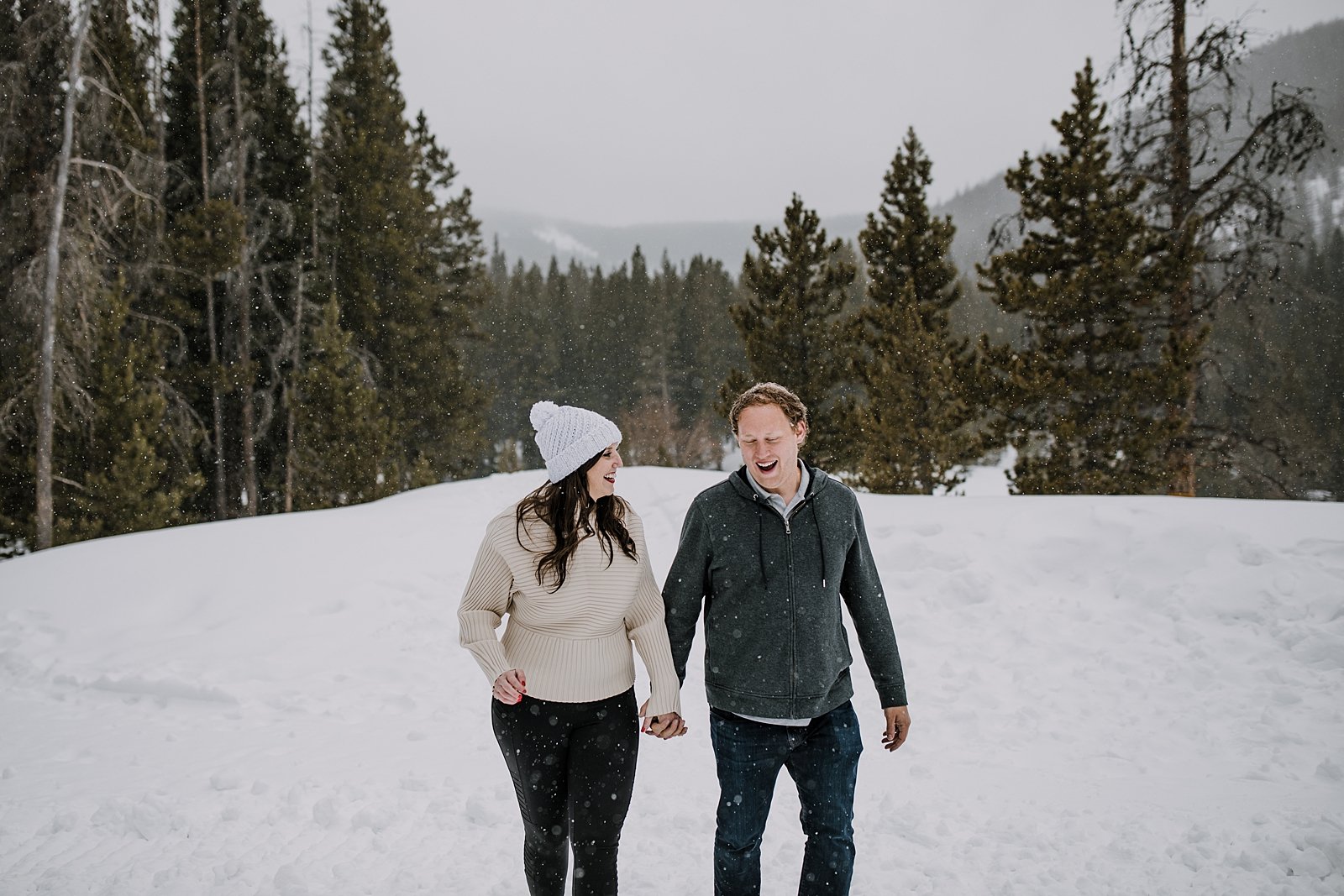 girl getting snow out of her hair, white bridal beanie, summit county elopement in the snow, breckenridge elopement in the snow, colorado elopement in the snow, breckenridge proposal photographer