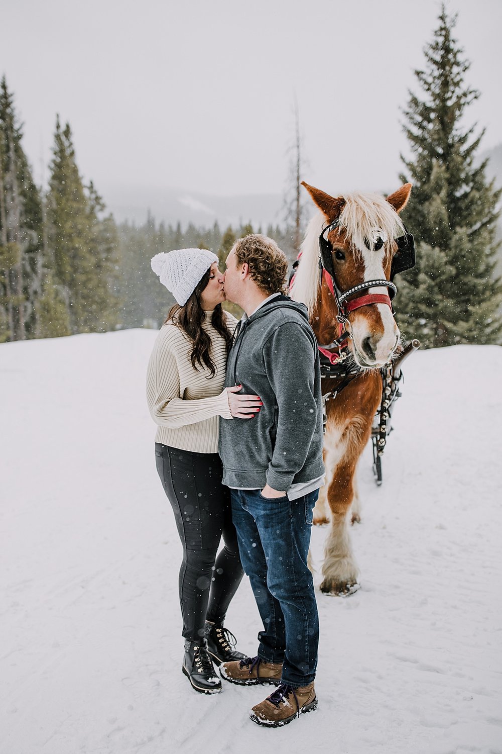 couple standing in front of horse, one horse open sleigh, colorado sleigh ride, breckenridge sleigh ride, summit county sleigh ride, percheron draft horse, colorado winter elopement photographer