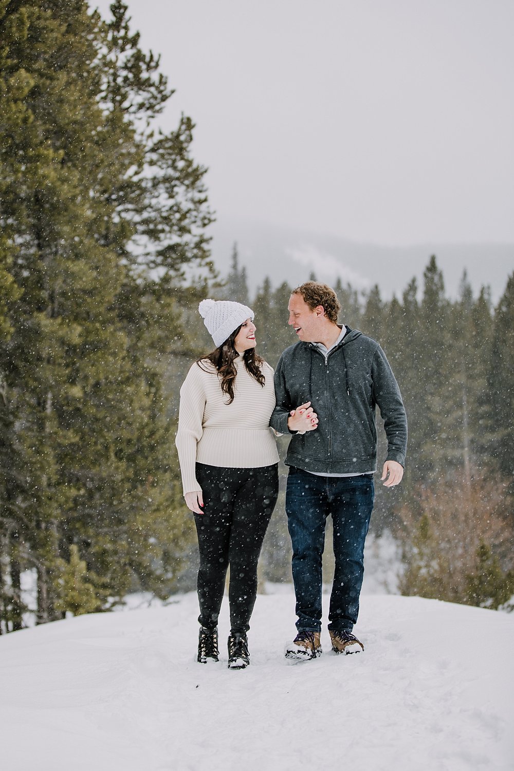 couple walking together in the snow, engagement ring in the snow, summit county winter engagement, breckenridge winter engagement, colorado winter engagement, leadville winter engagement