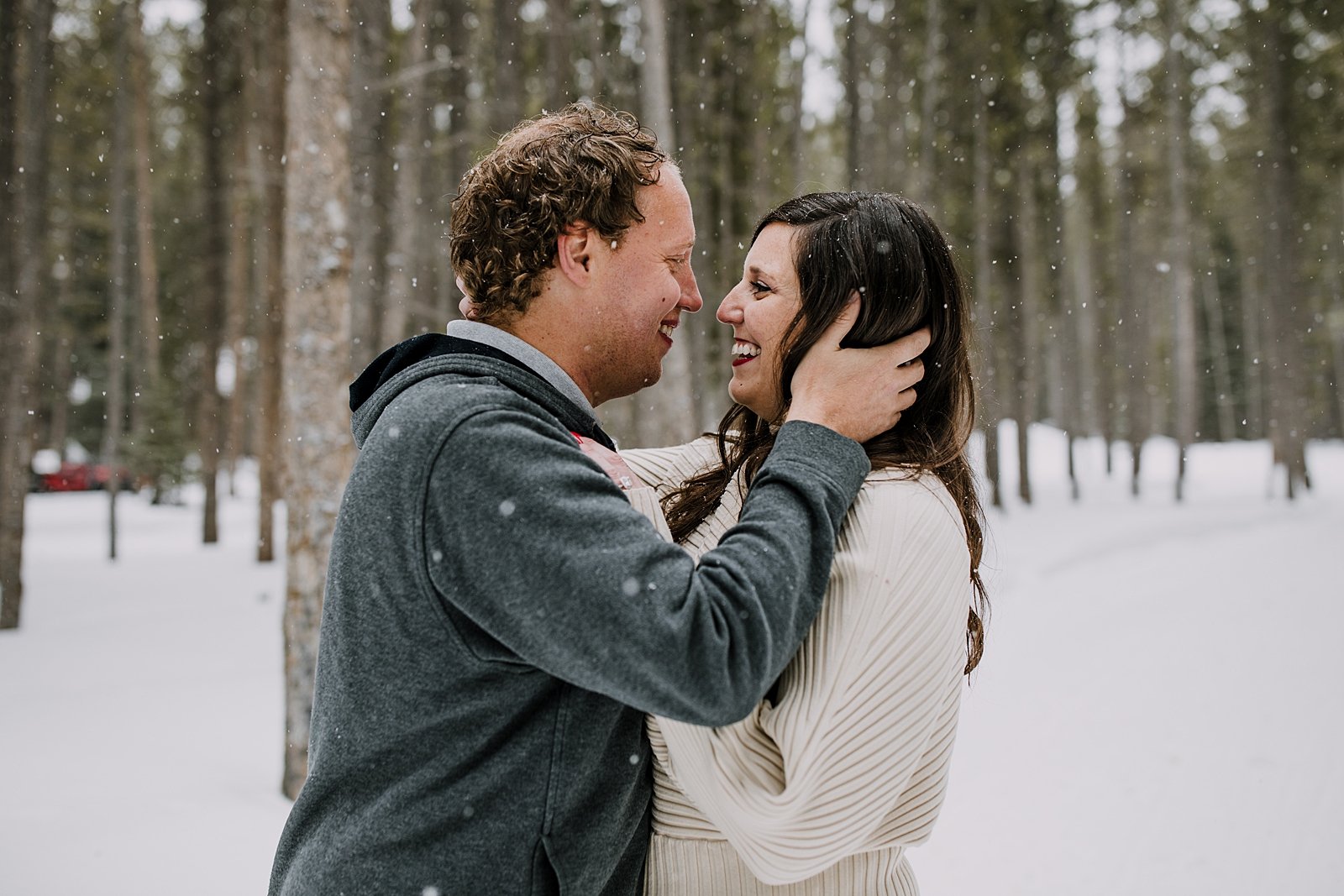 man pulling woman in for a kiss in the snow, golden horseshoe sleigh ride photographer, golden horseshoe sleigh ride proposal photographer, good times adventures photographer, winter engagement