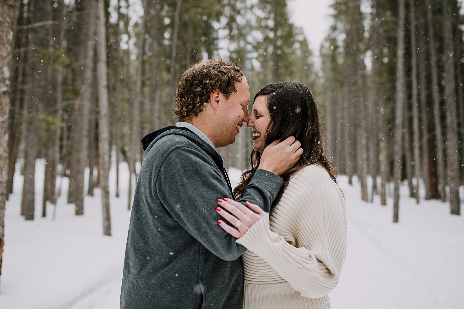 couple nuzzling noses in the snow, golden horseshoe sleigh ride photographer, golden horseshoe sleigh ride proposal photographer, good times adventures photographer, snowy mountain engagement