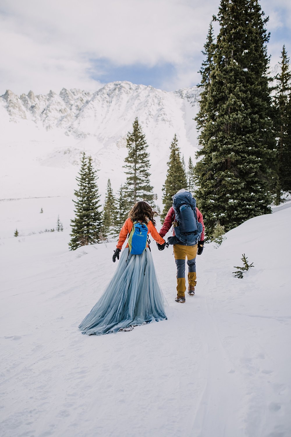 bride and groom hiking in the snow, mayflower gulch winter elopement, mayflower gulch elopement, leadville colorado elopement, leadville colorado winter elopement, snowy mountain wedding