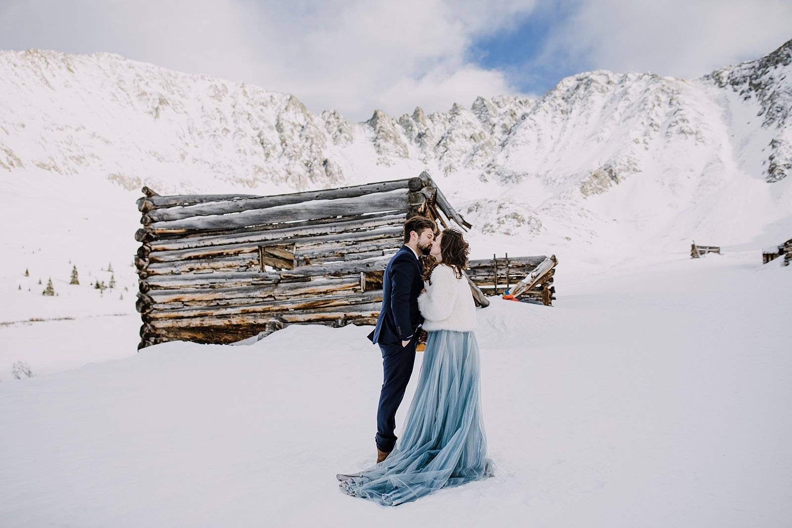 Bride and groom kiss in front of mountain scape, fletcher mountain, mayflower gulch elopement, leadville wedding, colorado winter elopement, best location for elopements in colorado