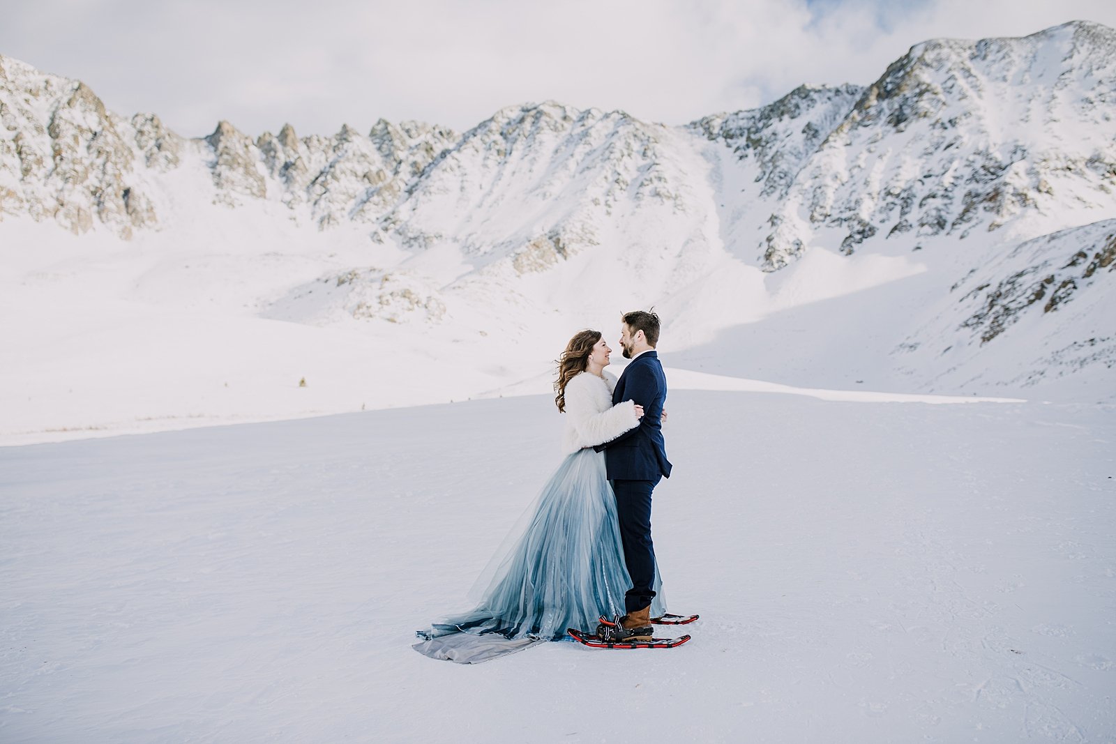 Bride and groom first dance, first dance in snowshoes, snowshoeing mayflower gulch, bride and groom embrace, winter landscape, colorado winter landscape, yukon charlies snowshoes