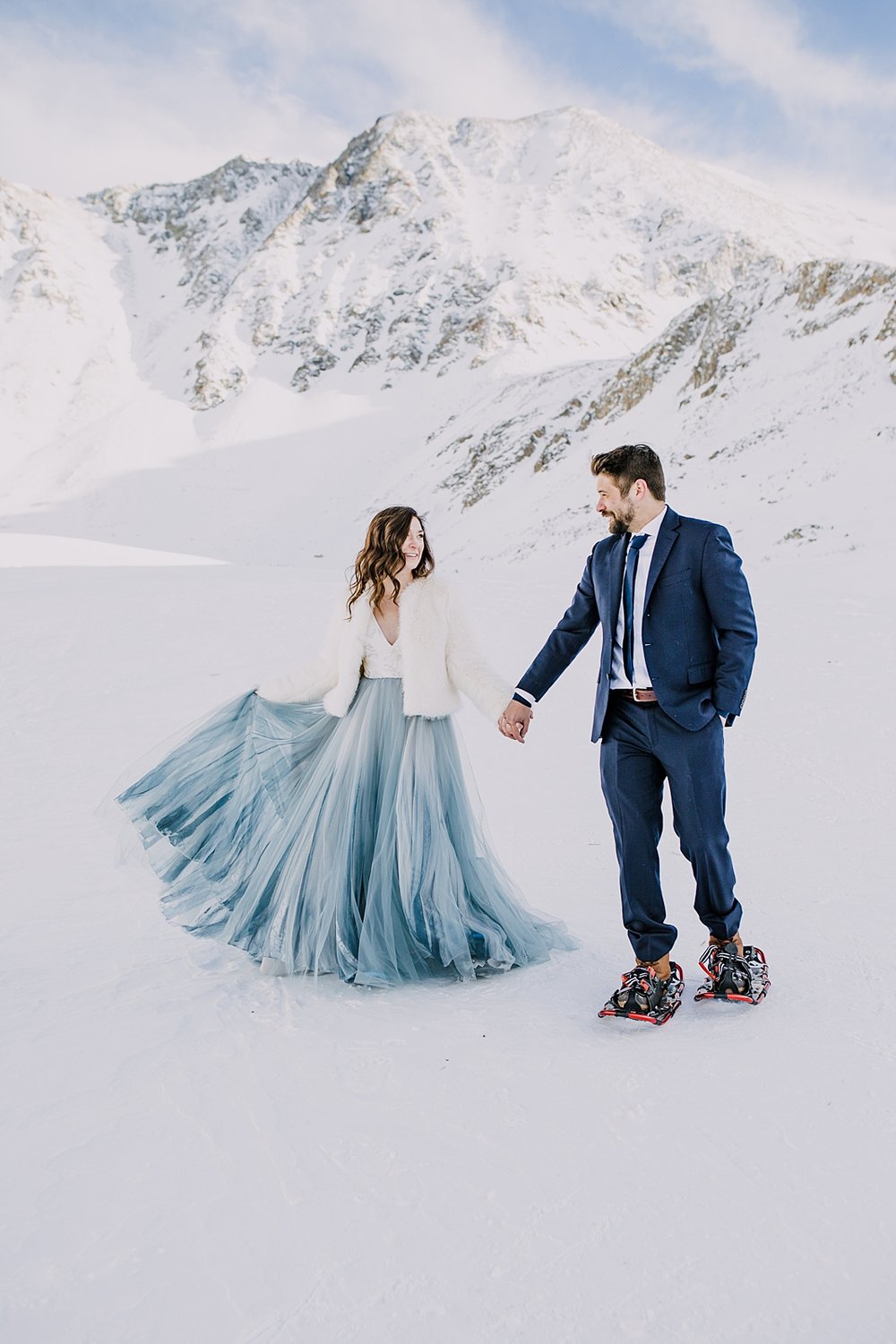 bride and groom snowshoeing, couple kiss in mountain valley, quandary mountain elopement, colorado snowy elopement, mountain valley elopement, mountain gulch elopement
