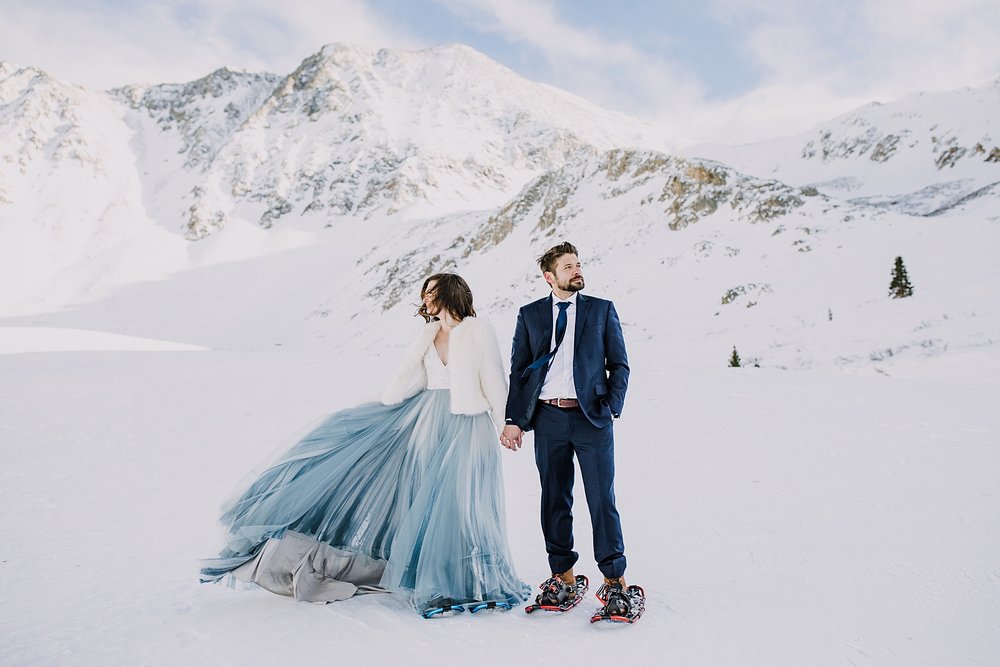 bride and groom holding hands, couple in mountain valley, quandary mountain elopement, colorado snowy elopement, mountain valley elopement, mountain gulch elopement