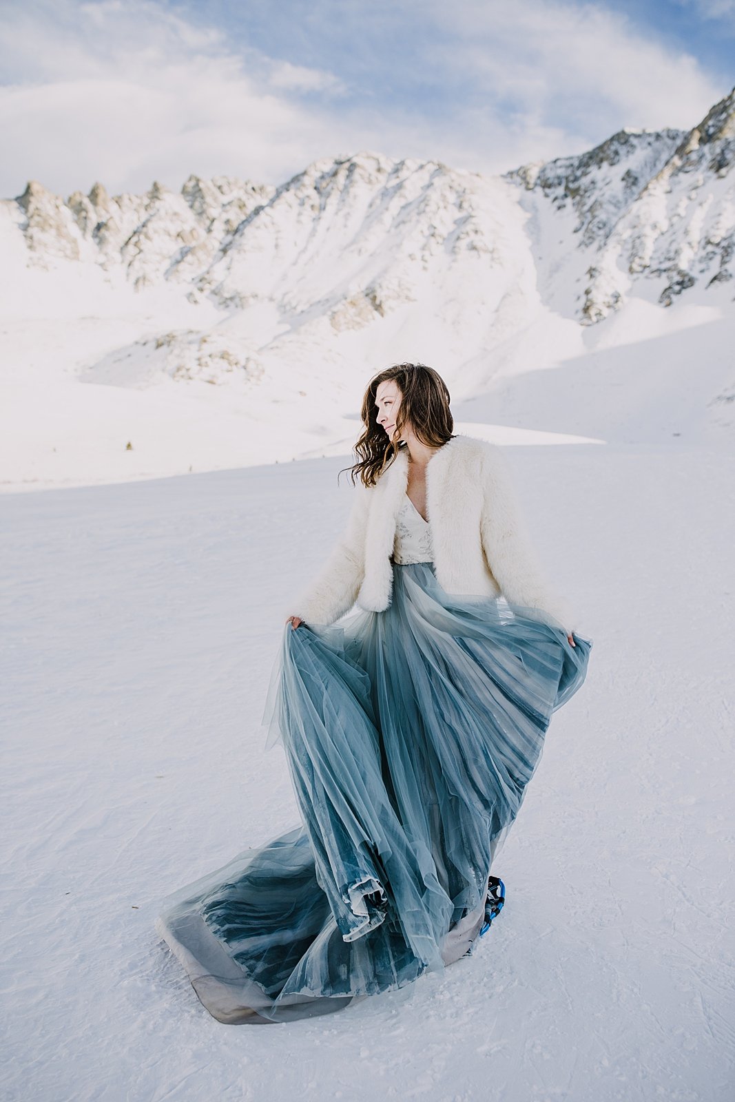 Bride twirling wedding dress, blue wedding skirt, bride dancing in mountain valley, bride in the snow, colorado bride in winter