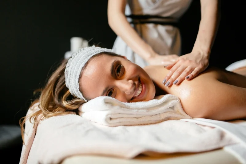 Woman is happy that she is receiving a massage