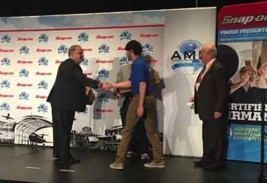International Representative Chris Moore presents a set of Snap-on tools to the winner of the student raffle at the MRO Convention