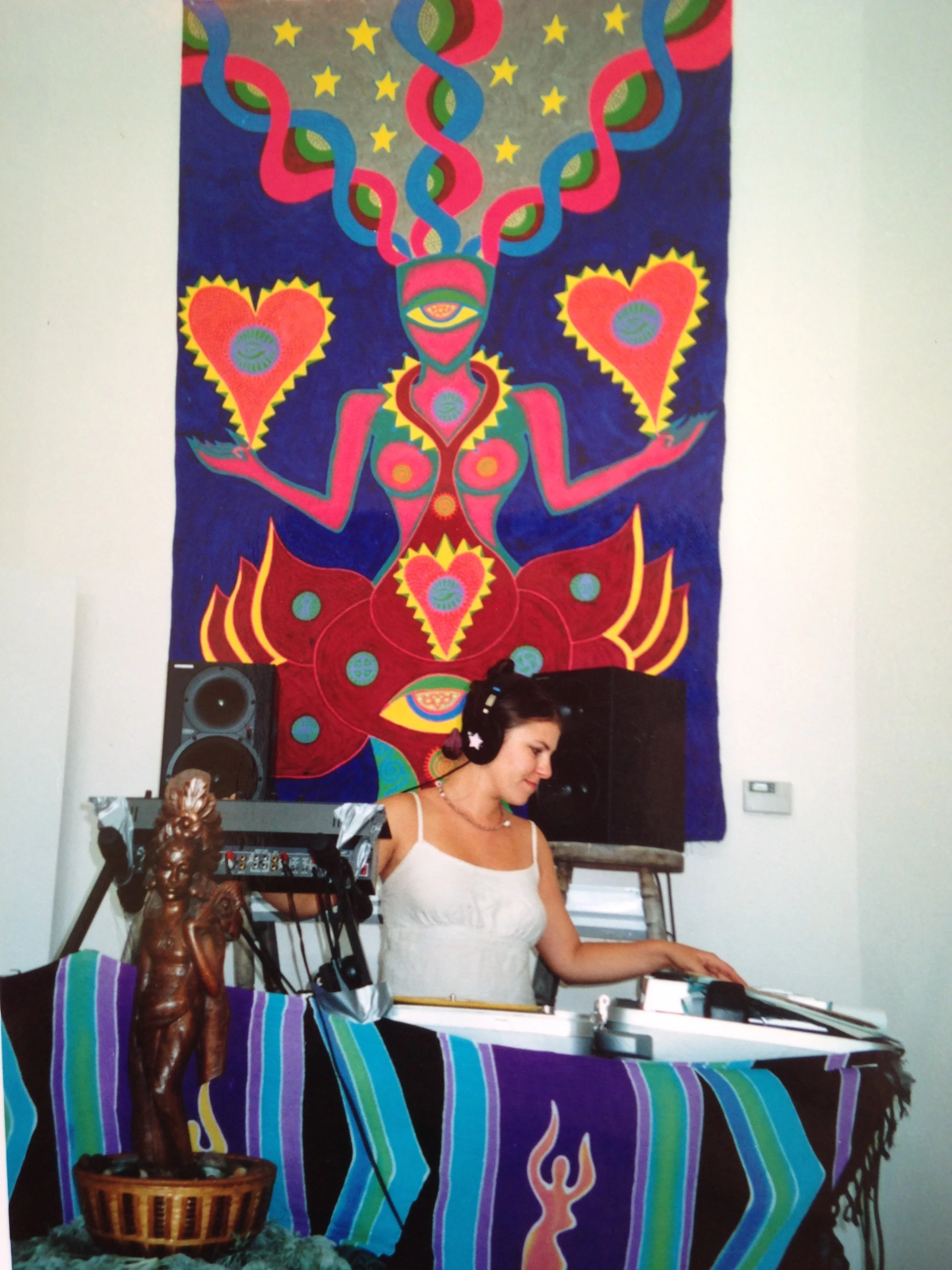 DJing in front of a blacklight-active backdrop I painted