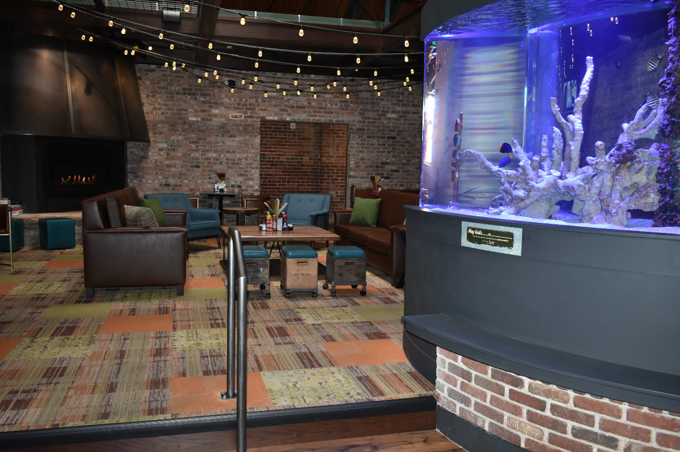 The inside of the new Cherry Cricket in the Ballpark Neighborhood. The new location includes the classic fish tank in addition to the vast seating space and bar area. (Credit: Sarah Ford) 
