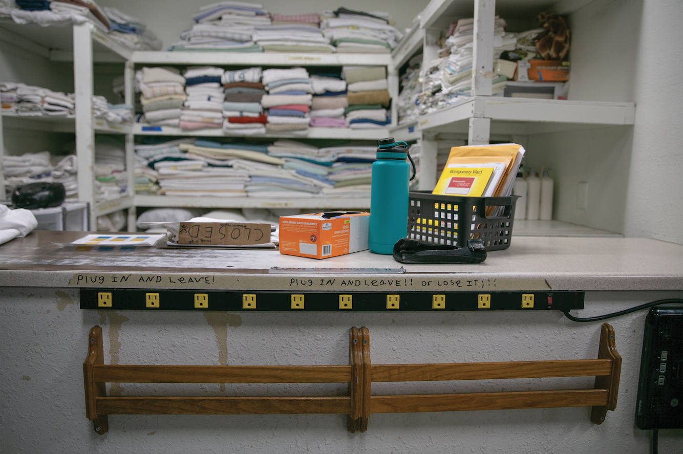 Every morning, staff and volunteers at Homeward Bound, which provides beds for 120 unhoused individuals, wash the sheets to ensure a fresh bed. Credit: Giles Clasen