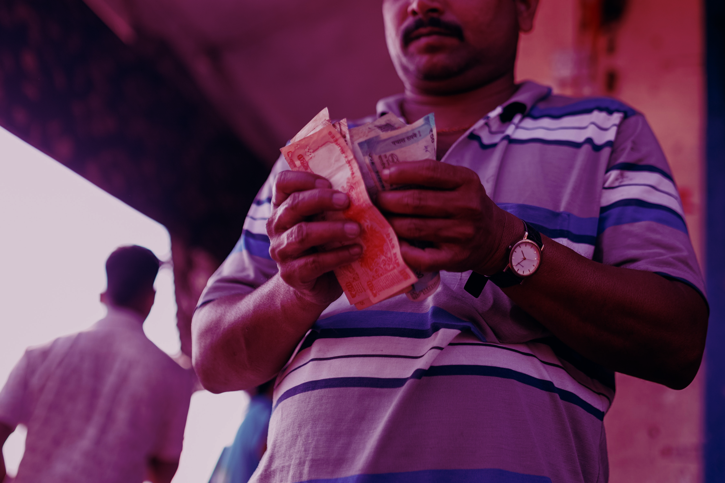 man-in-blue-and-white-stripe-polo-shirt-holding-banknote-4427643-1.png