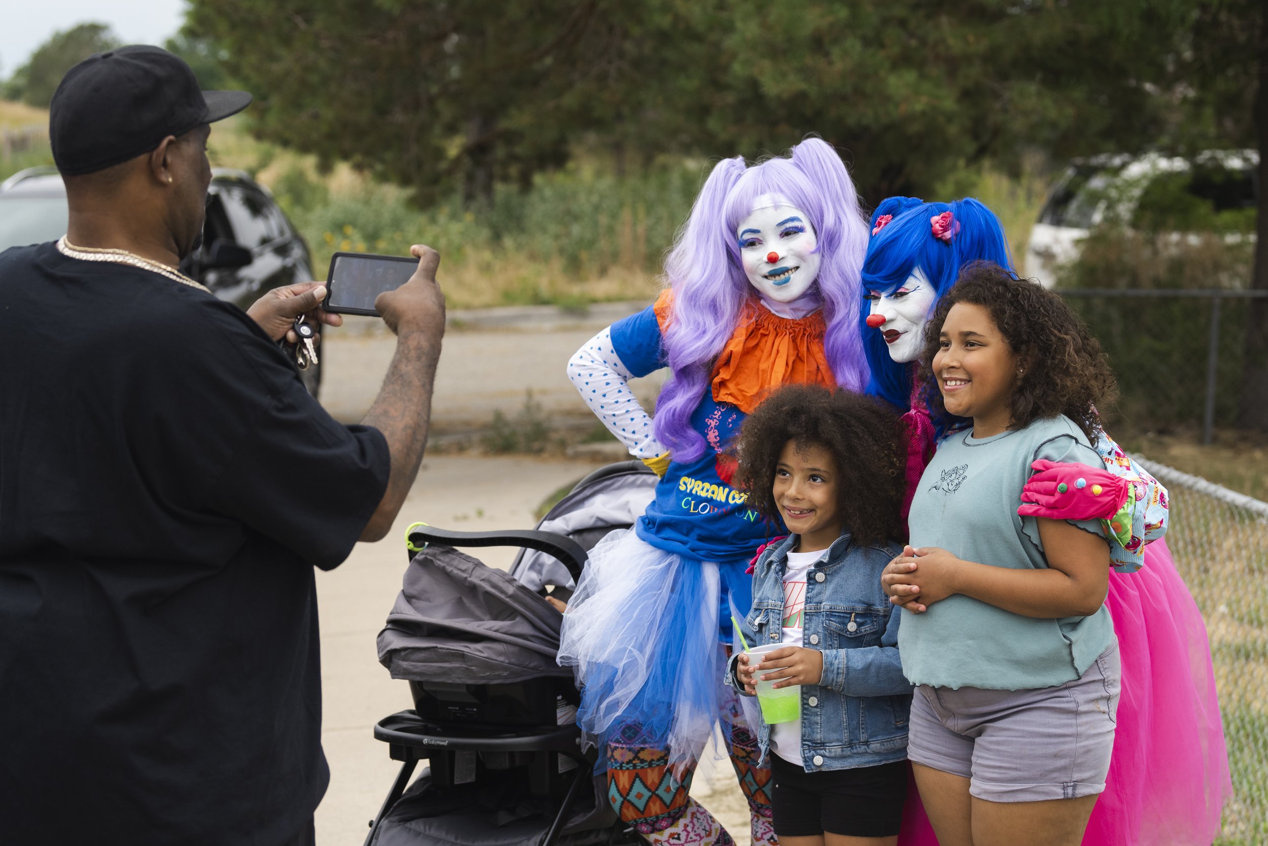  Clowns BlahAwesome &amp; Rhythm pose with children. Photo: Adrian Michael 