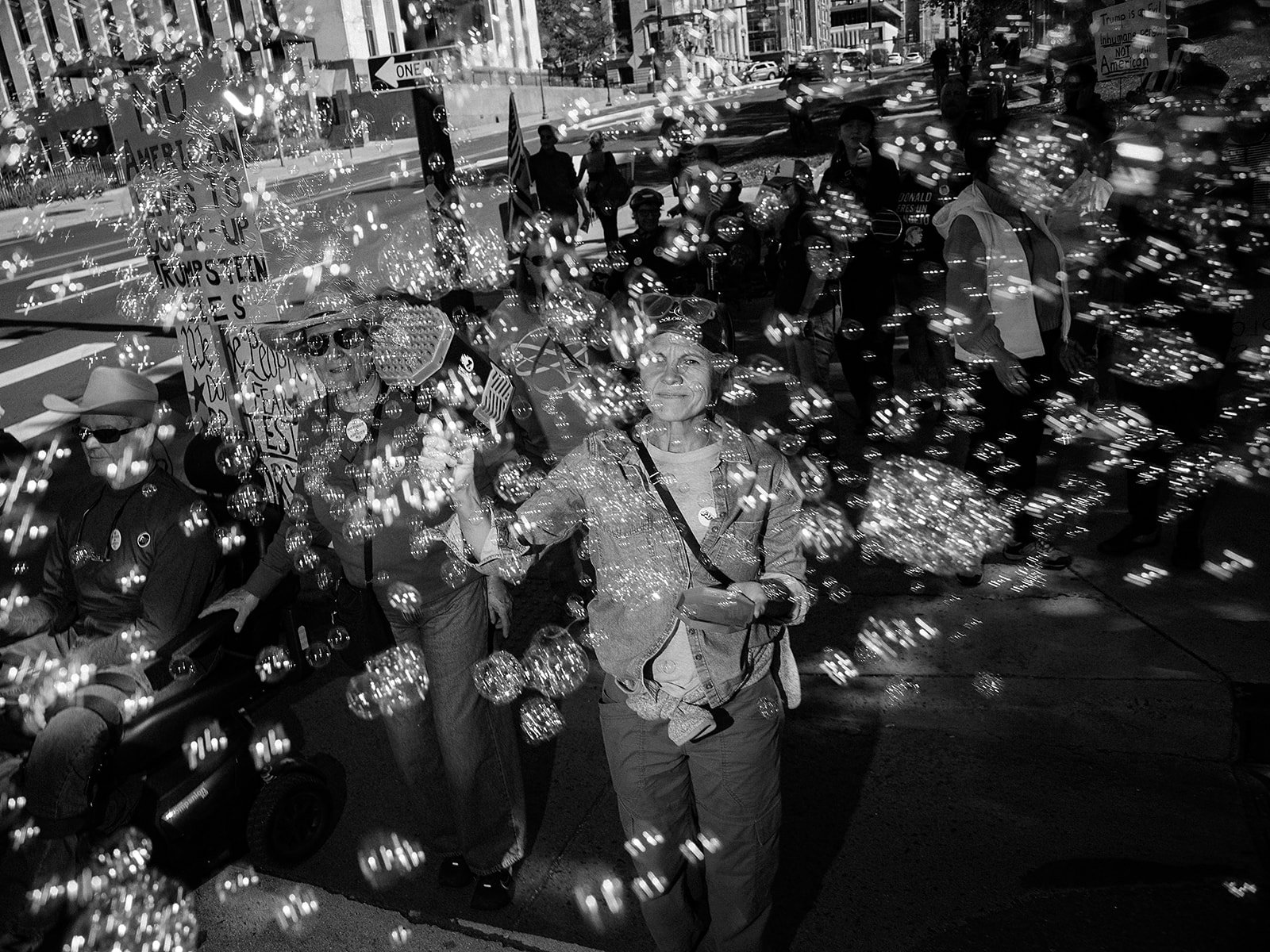 Bubbles drift through a crowd of demonstrators marching through downtown Denver during the No Kings protest on Saturday, Oct. 17, 2026. Photo by Jeff Tidwell for the Denver Voice.