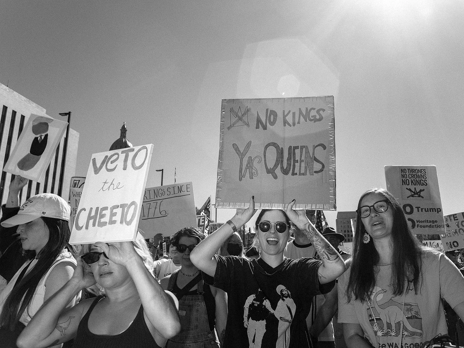 Participants display handmade signs while crossing downtown Denver during the No Kings protest on Saturday, Oct. 17, 2026. Photo by Jeff Tidwell for the Denver Voice.