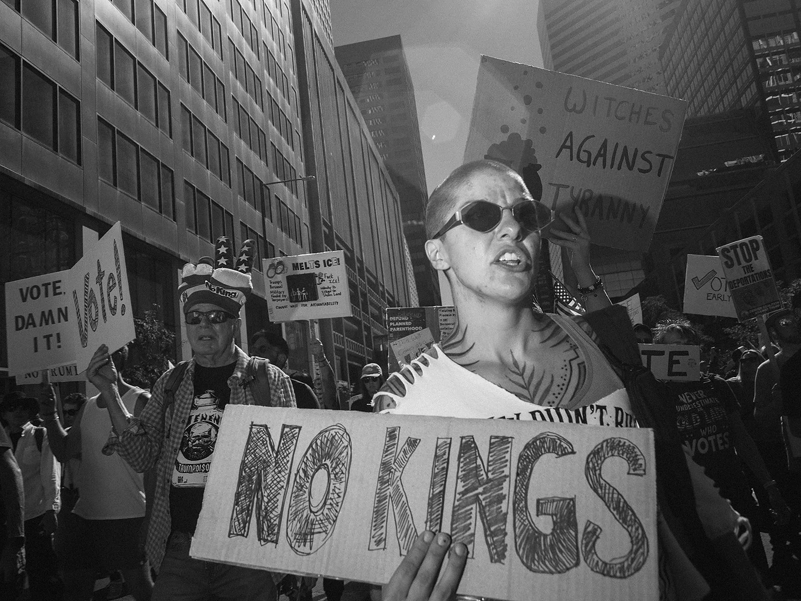Demonstrators stream between downtown office towers on Saturday, Oct. 17, 2026. Photo by Jeff Tidwell for the Denver Voice.