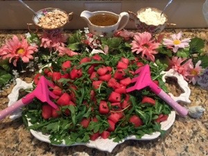 Watermelon Mint Arugula Salad. Top if off with feta and almonds and a red wine vinaigrette dressing with olive oil and lemon juice. Used garden rakes instead of tongs.