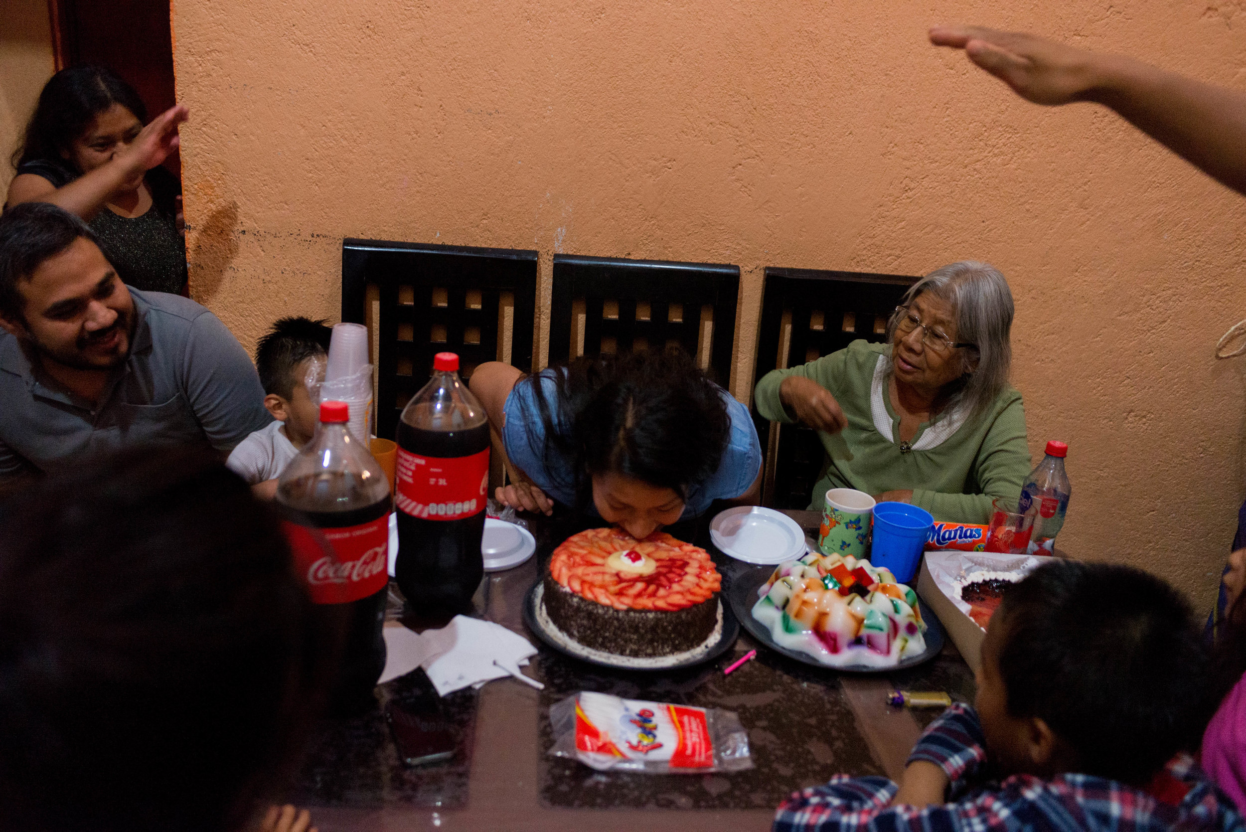  Marlen celebrates her 27th birthday as her family cheers for her to put her face into her cake. 