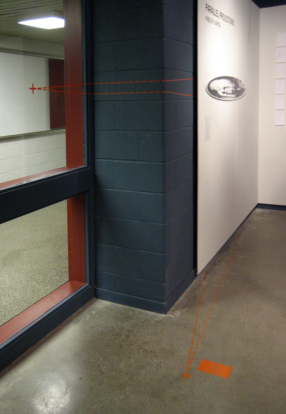 Installation view, with projection lines marking the wall and floor to guide the viewer to the precise vantage point location.