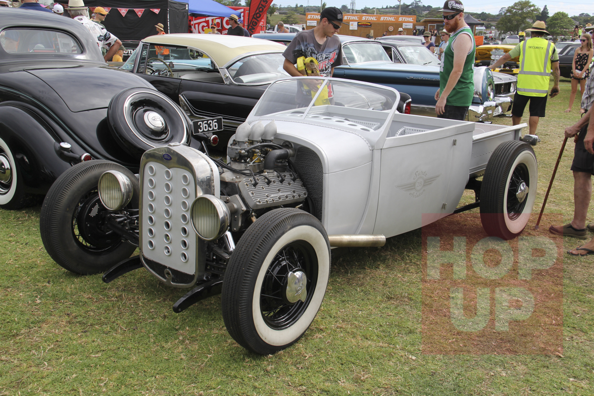 Neil Surtees is one very clever man. His Model A roadster pickup features a handcrafted (by Neil) all aluminium body with over 5000 rivets holding it together. The detail is incredible and some of the features include a pickup bed which slides back to access the rear radiators for the flathead Ford V8 engine. The chassis is underslung and the screen is slightly curved but emulates a later early Ford shape.