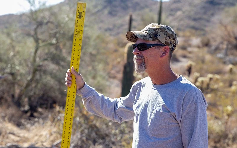 Jed Nitso frequently hauls truckloads of water to catchments across the state. “On a weekly basis, I get to go into a lot of places where other people just go when they're hunting,” Nitso said. (Photo by Nick Serpa/Cronkite News