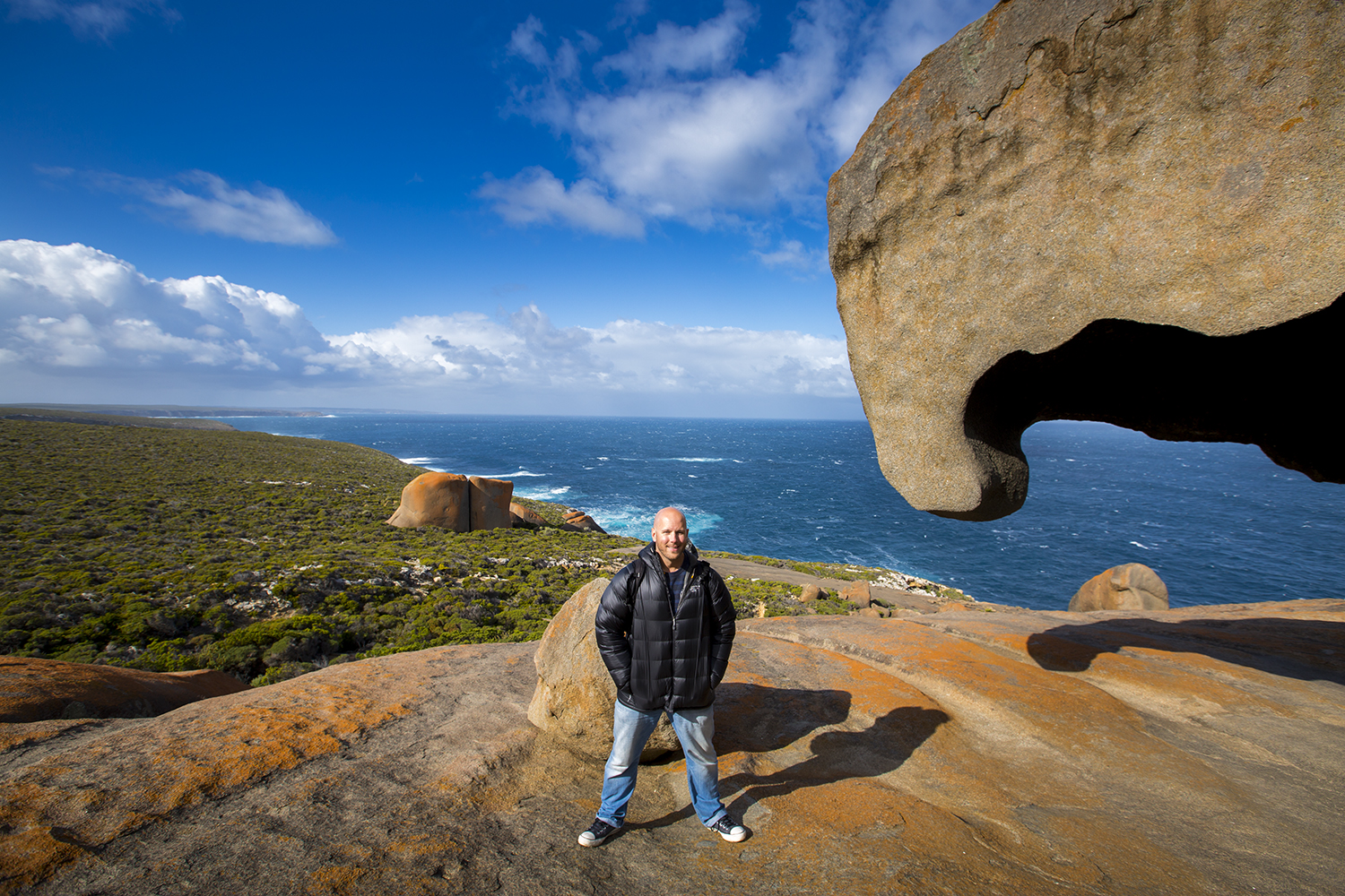 Earth Trotter Photos' Chris Taylor stands atop Remarkable Rocks on Kangaroo Island near Adelaide, Australia.