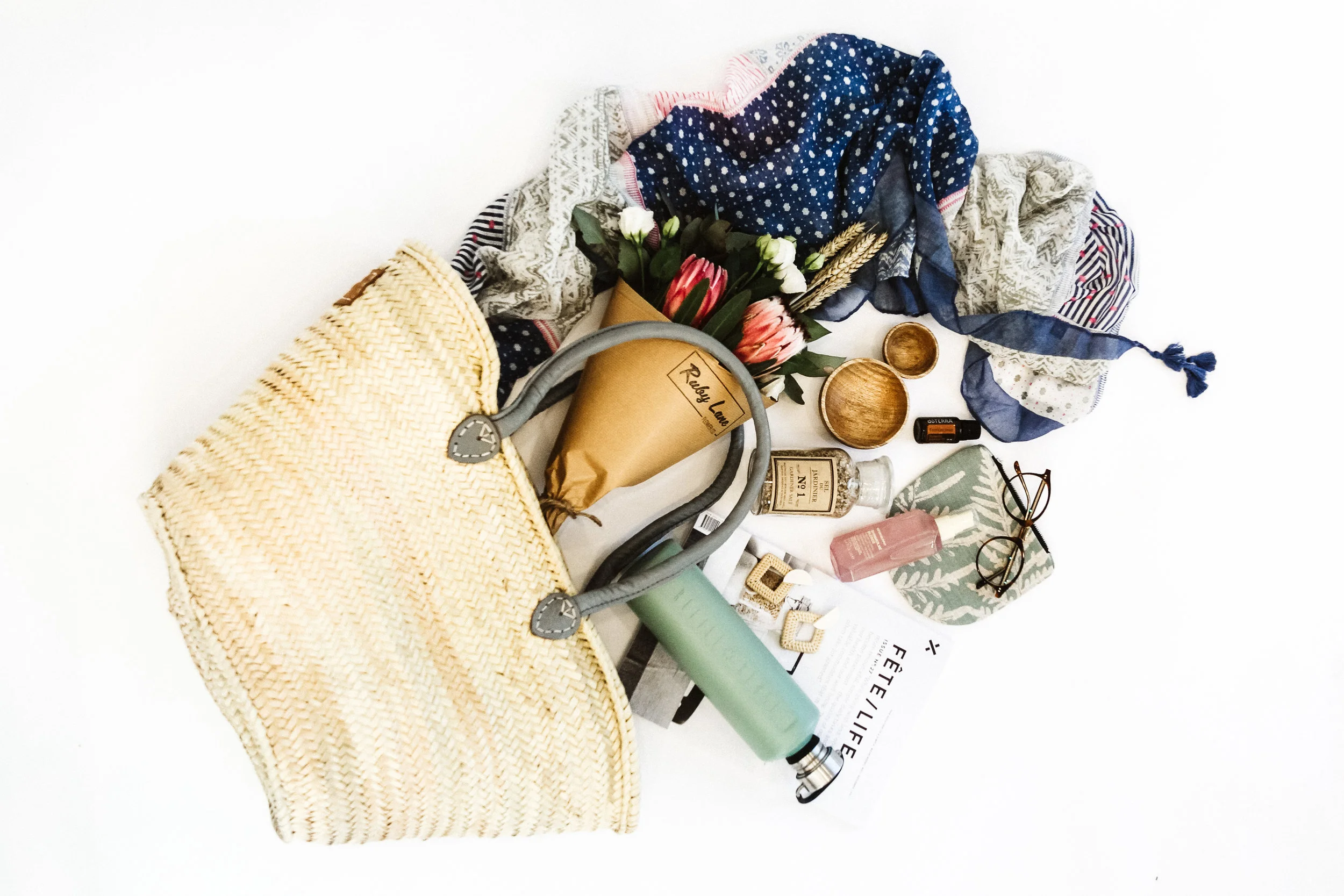 Products Clockwise L-R: French Market Basket from The Bungalow & Basket ($65) | Scarf from Florence & Marabel ($45) | Bouquet from Ruby Lane Flower Co ($30) | Wooden Bowls from The Bungalow & Basket ($6-10) | Frankincense Essential Oil from Live Pure & Simple ($) | Linen Pouch from The Bungalow & Basket ($29) | Reading Glasses from Bailey Nelson (from $175) | Kevin Murphy Shimmer Spray from Profile Hair Design ($) | Gourmet Salt from Harold's ($25) | Straw Earrings from Florence & Marabel ($40) | Water Bottle from Live Pure & Simple ($33)