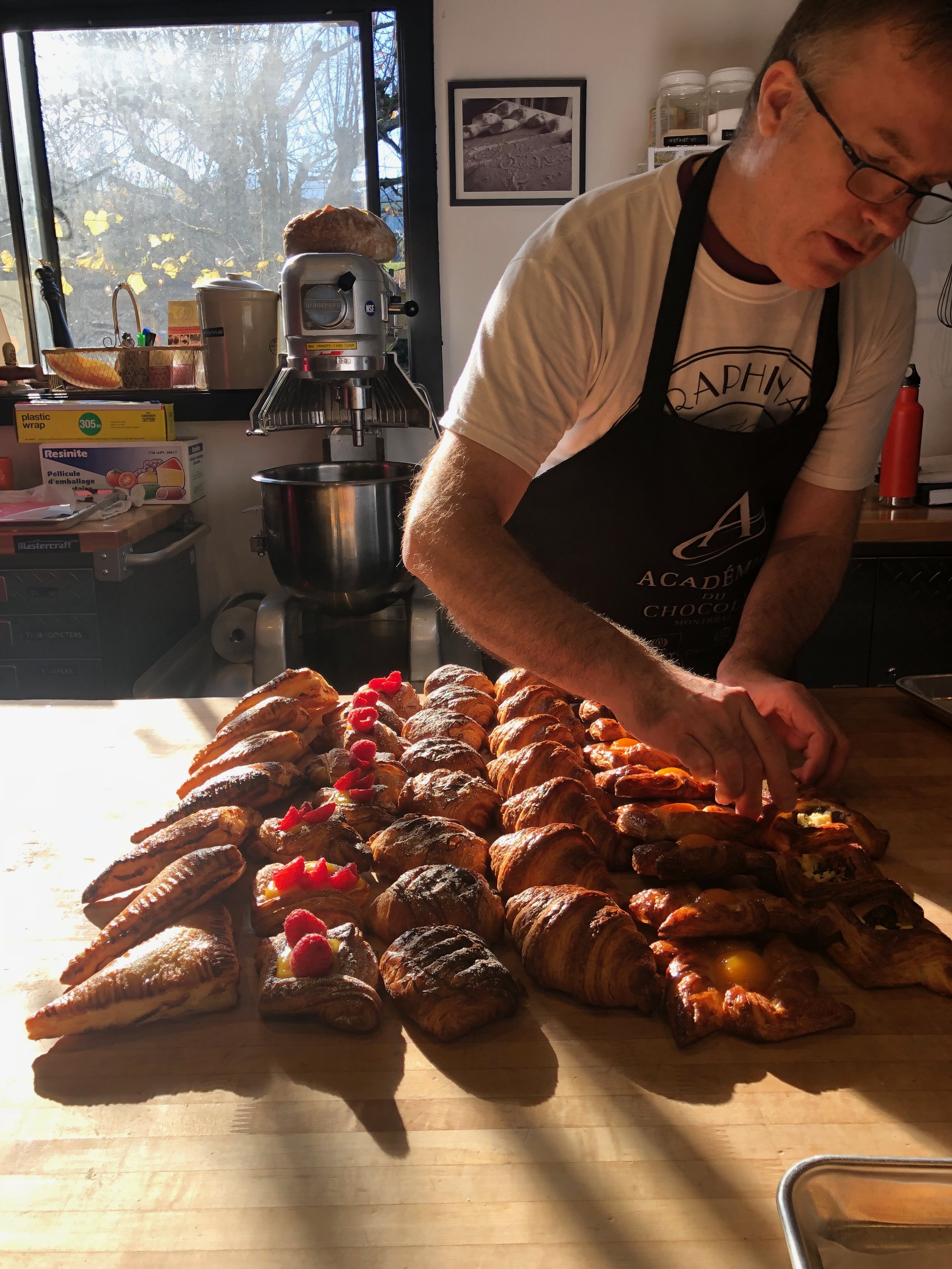 Chef David Nolan displaying croissant and danish at Seraphina's Oven