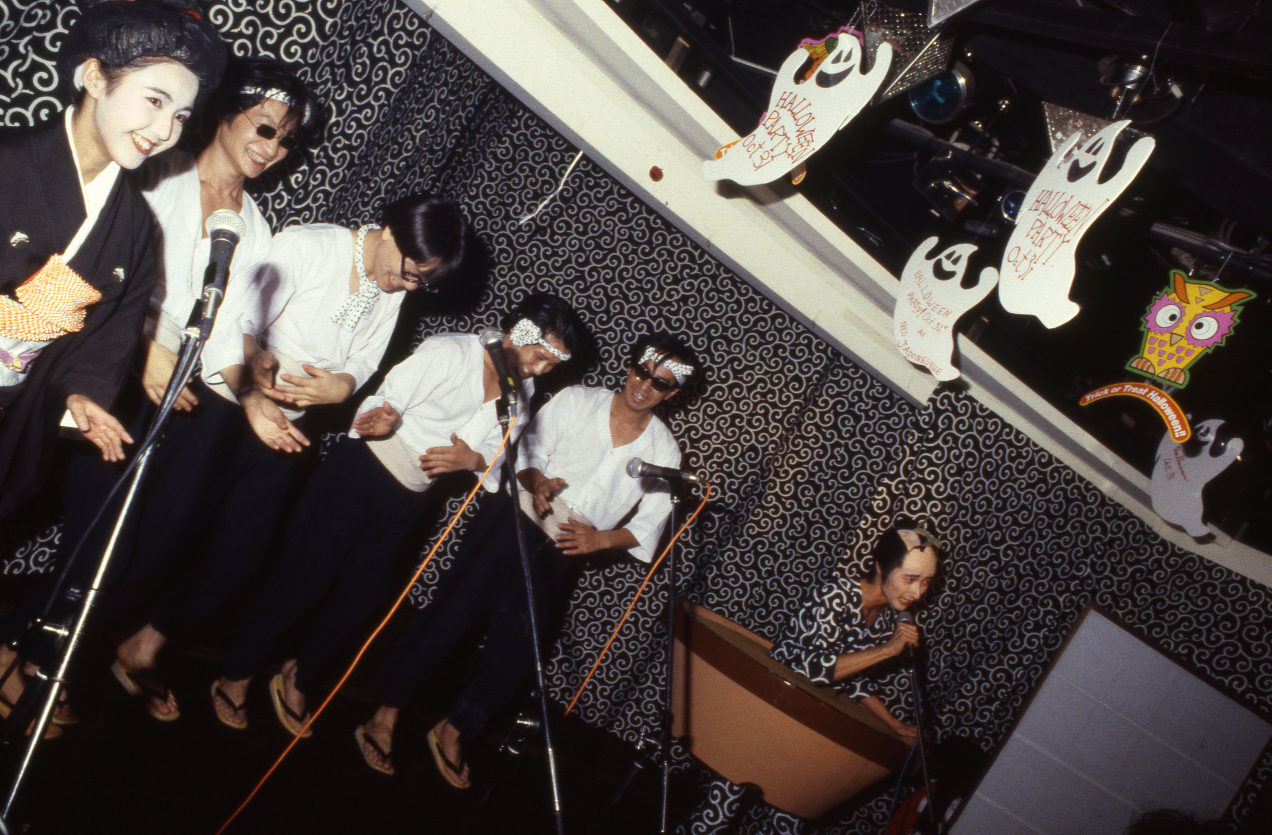 Numata Genqui performing as the "Bonsai Kozoh," with chorus. Roppongi, Tokyo, ca. 1986