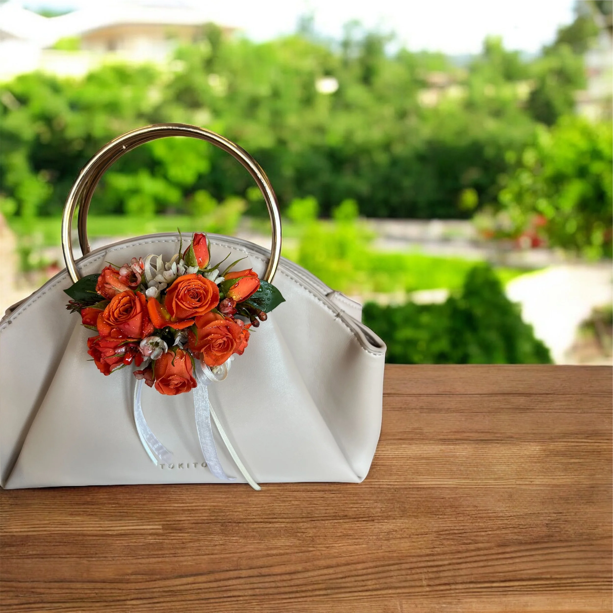 Elegant tan Tokito handbag featuring a floral corsage attachment, perfect for Mother of the Bride wedding flowers and accessories in Perth.