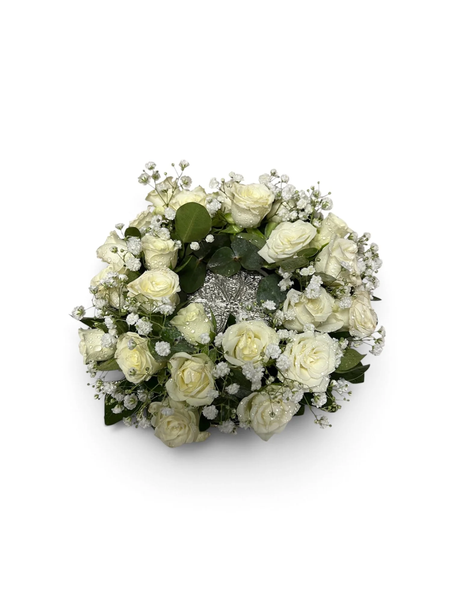 white spray rose round arrangement with space in the middle for jewellery box placed on a silver dish with stand