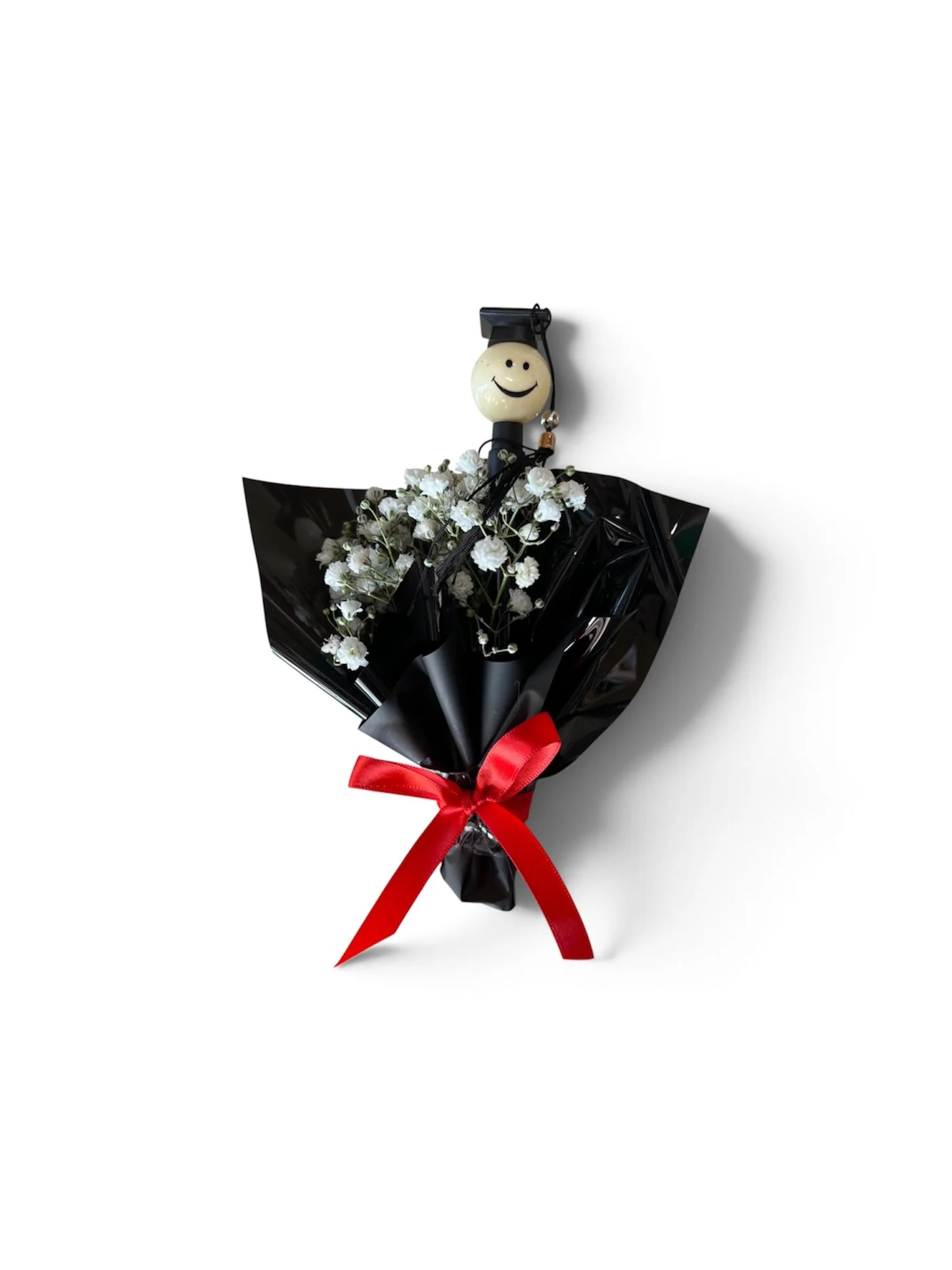 Fresh baby’s breath graduation bouquet with smiley-face graduation cap pen, wrapped with a bow