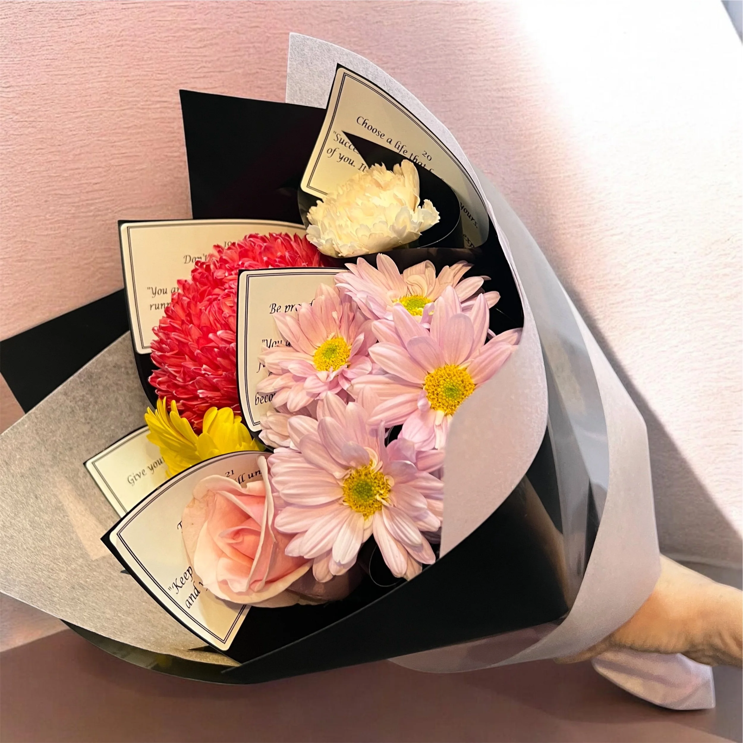 Five individually wrapped flowers with encouraging messages for ages 17 to 21 in Lilypilly's A Life in Bloom graduation bouquet.