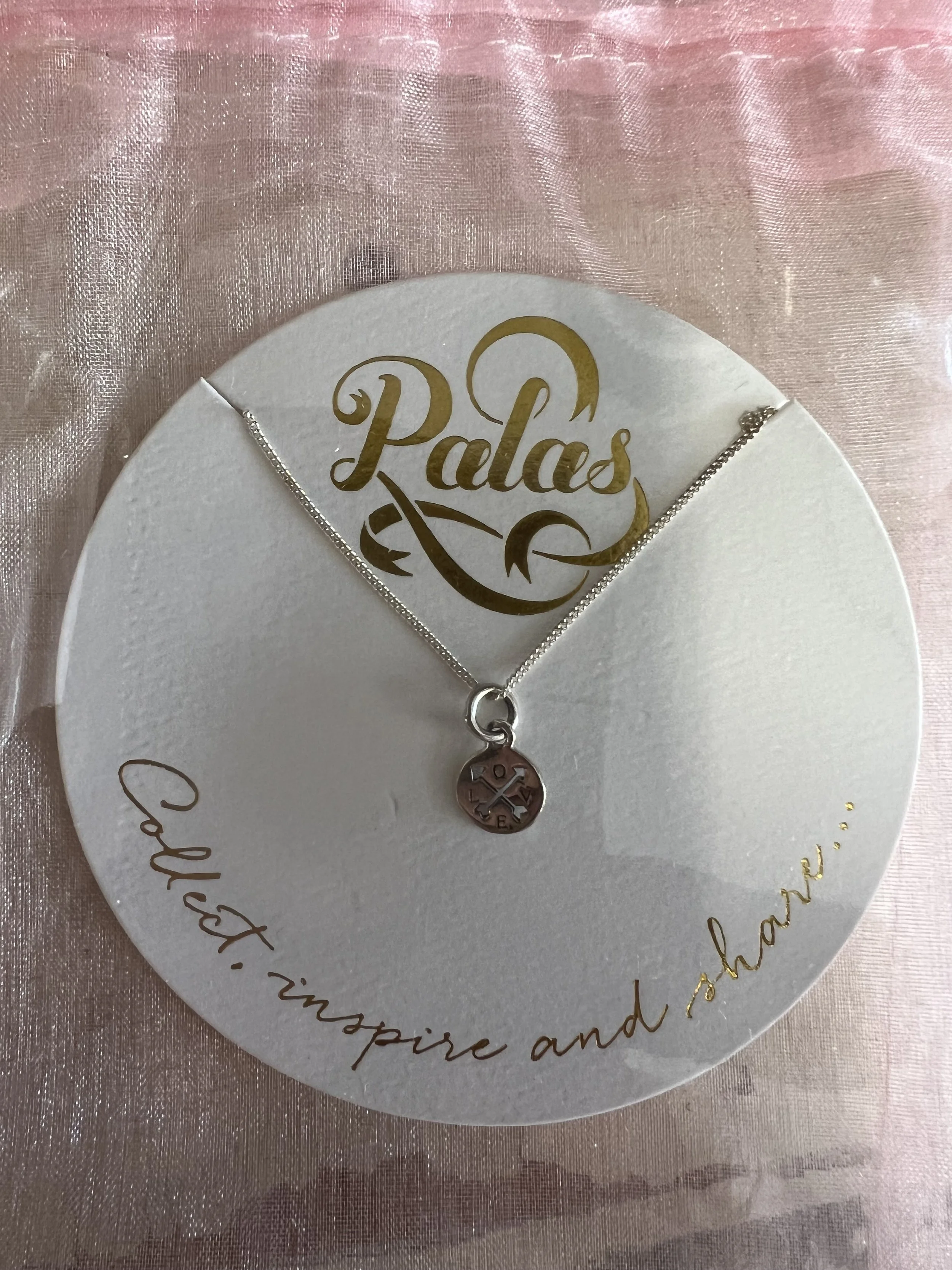 Palas Jewellery charm necklace in silver presented in an organza gift bag, available as a gift or paired with flowers.