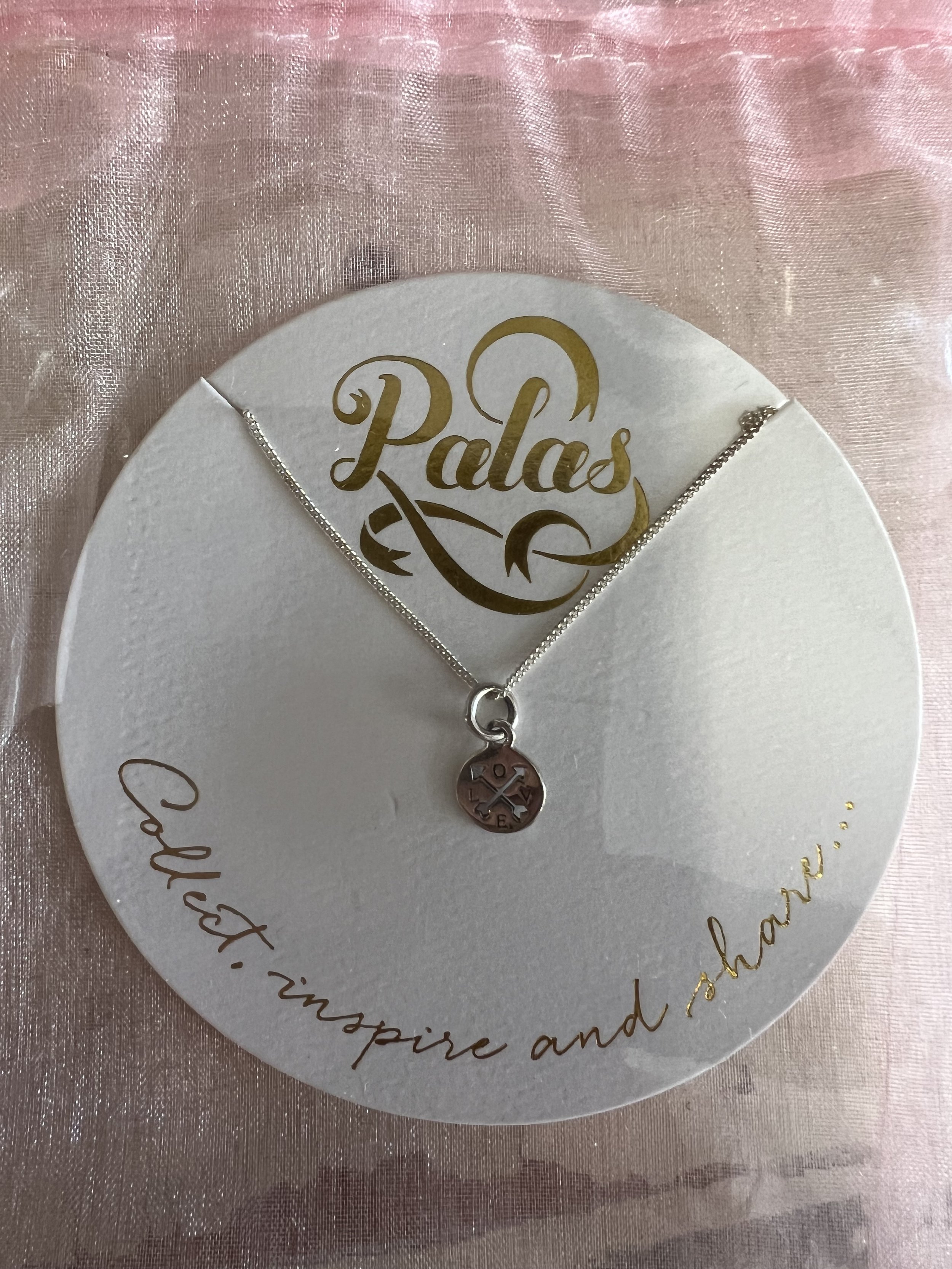 Palas Jewellery charm necklace in silver presented in an organza gift bag, available as a gift or paired with flowers.