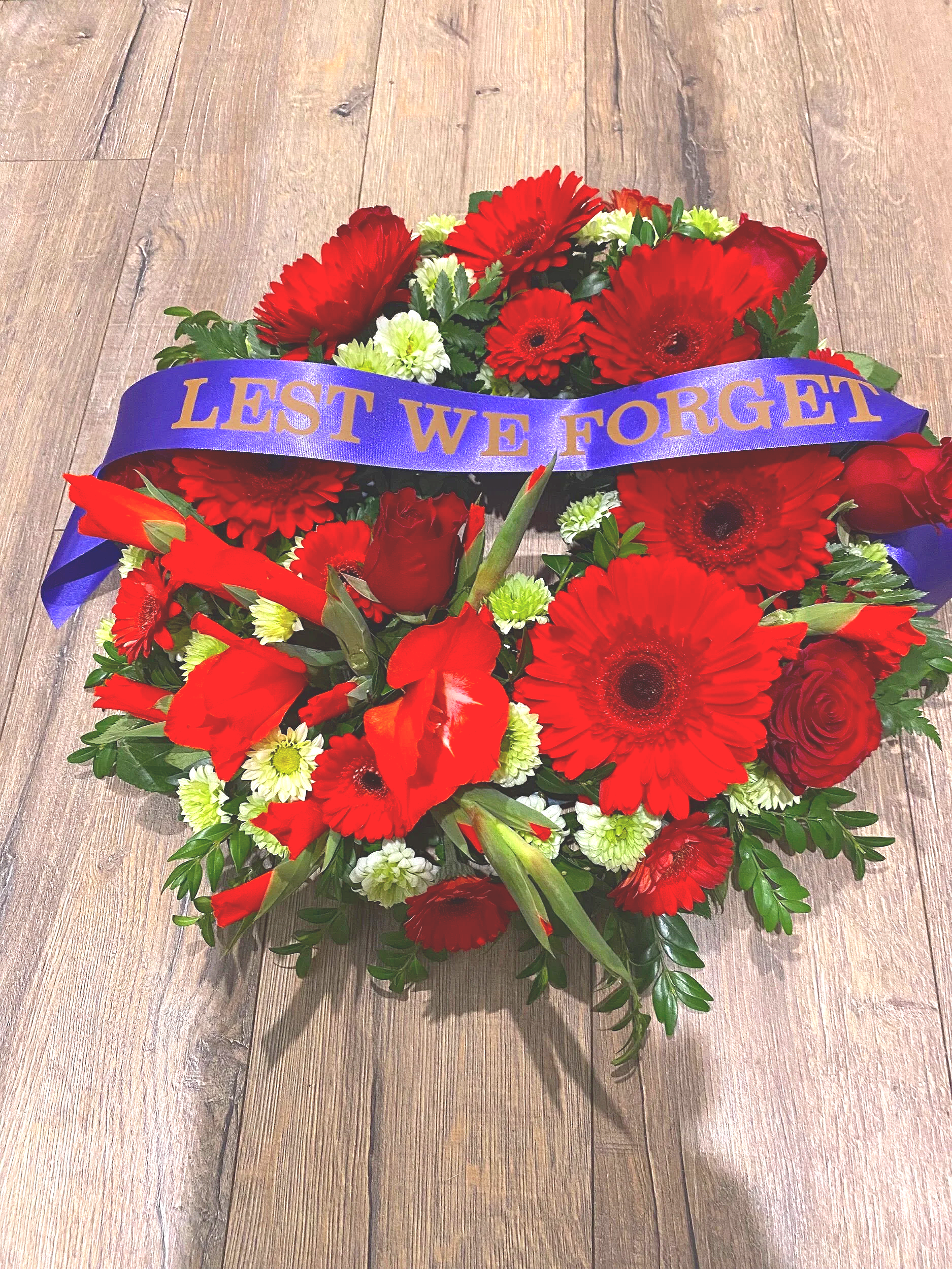 red and green lest we forget ribboned wreath