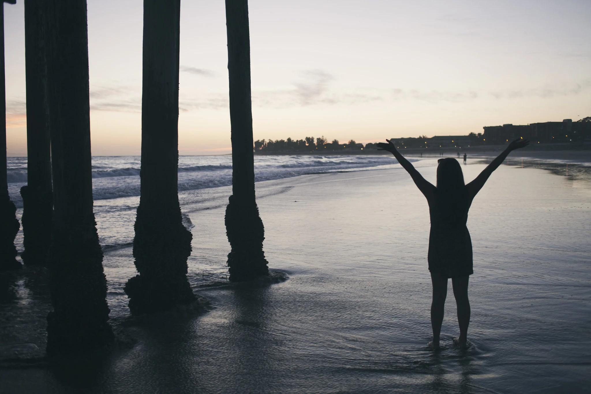 silhouette-of-woman-standing-with-arms-raised-in-the-water.jpg