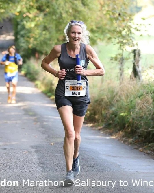 A healthy woman running in a race, looking fit and strong