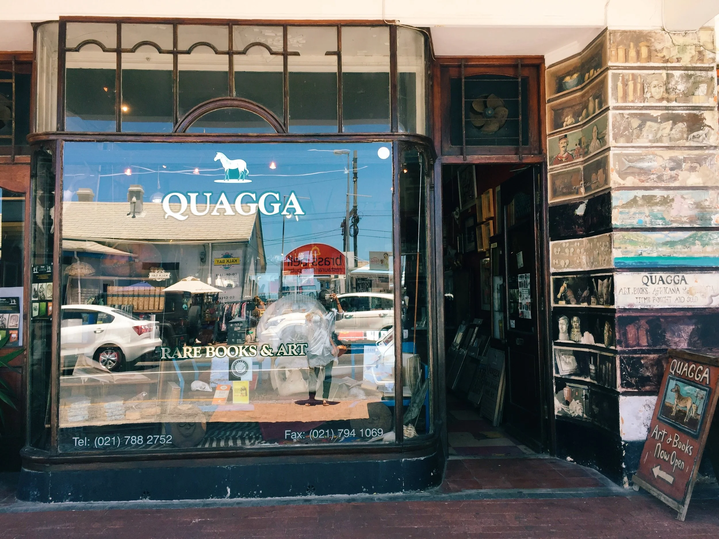 Serendipity and Google together can lead you to amazing finds. On a car ride through Kalk Bay earlier on the trip my eyes caught sight of this interesting rare books and art shop but did not remember the name or the exact locale. On a Thursday a week later, the volunteer work finished early so I tried to Google the shop that still leaves an impression on me. Fortunately, Kalk Bay where the shop is situated is only 45 mins walk from Muizenberg, and with the beautiful weather, I was there in no time. Got physically harassed by the locals on the way but this quaint little shop with massive collection very much lifted my mood. The smell of dust, old parchments and wood hit as soon as I took a step in, with a smiling young man greeted me from behind the shelves and a gray-haired, seasoned gentleman named George with sharp eyes looking kindly at me from behind the counter. It was a perfect store-visit experience, an endless amount of rare books, prints, illustrations, original vintage maps, ephemera surrounding every nooks and crannies of the shop, the service that is friendly yet gives you space to explore on your own, the interior that gave you the sense of going back through time in a foreign yet oddly familiar land. After numerous visits and purchases of one vintage map of South Africa dating back to 1756, 3 rare books on South Africa and its history, 3 vintage books on hotels and travel, George gave me a book about Michelangelo free-of-charge. Hands down, Quagga is the best bookstore I've been to.