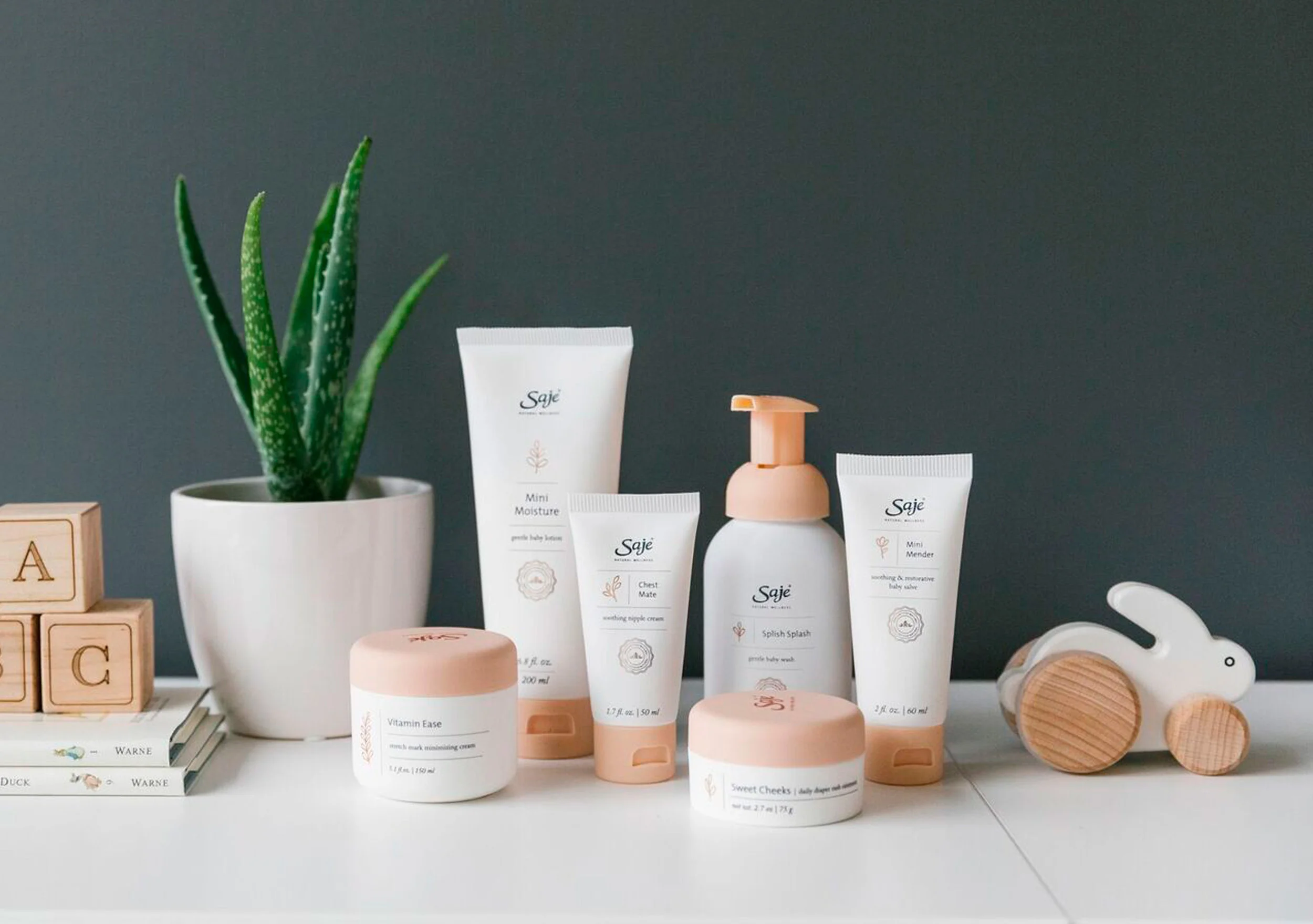 The 100% natural baby care packaging was designed to feel smooth, like a baby’s skin. The design features white soft touch materials with the colour peach, inspired by a budding new flower. The front panel features a copper baby botanical that illustrates the sequence of a new sprouting plant. The products included a baby wash, moisturizer and healing salve for babies, and a stretch mark cream and nipple ointment for mothers.