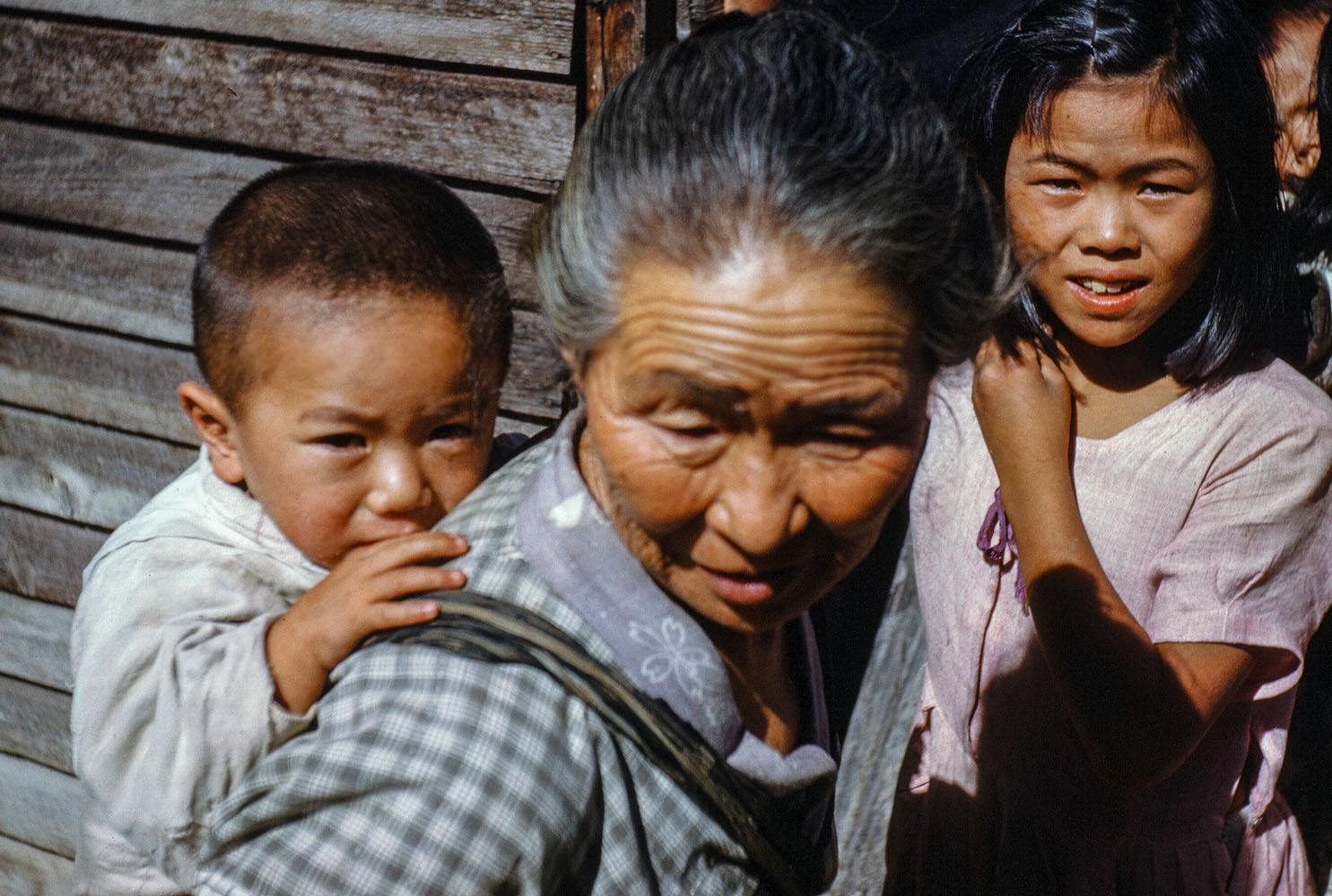 101 Older Woman with Baby on Back, Young Girl