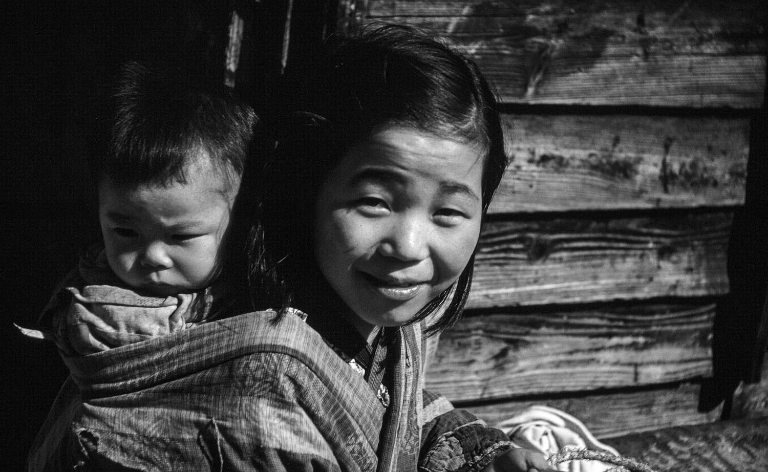 103 Young Girl with Baby on Back