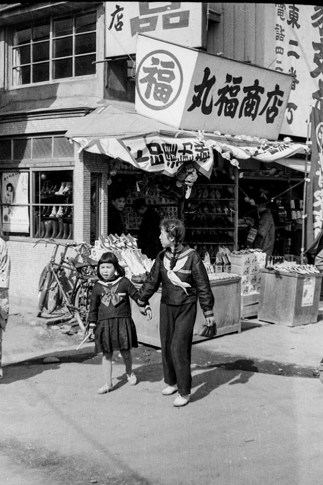 218- Young Girls in front of Shop