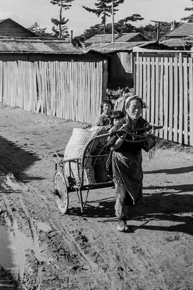 339-Woman Pulling Hand Cart with Small Child