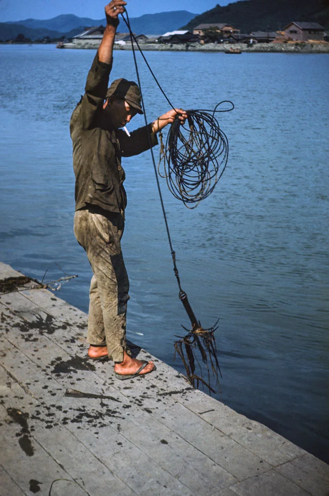 412-Man Pulling Anchor from Water