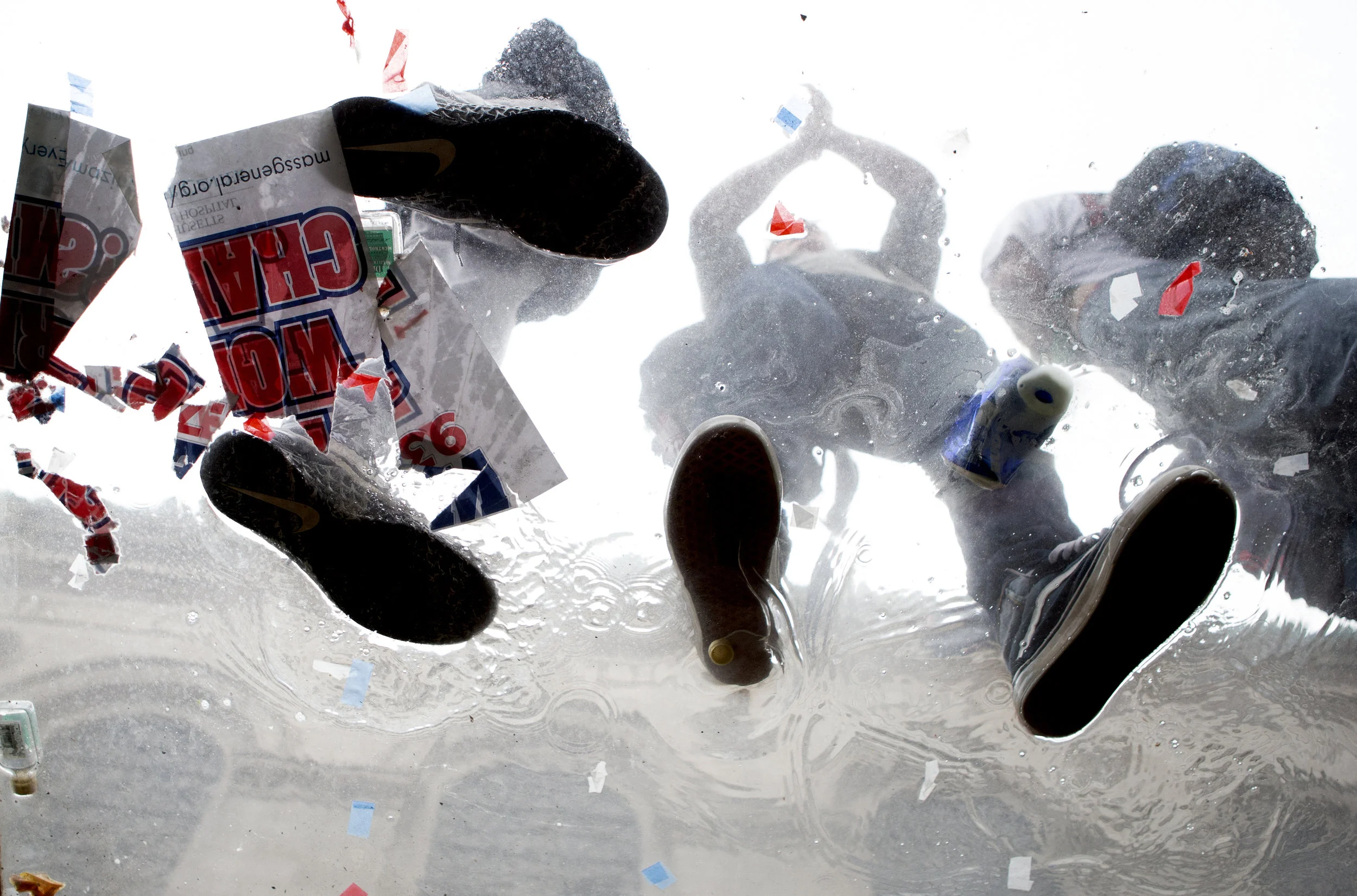 Fans watch the Red Sox World Series parade in puddles of beer on top of bus stops on Oct. 31