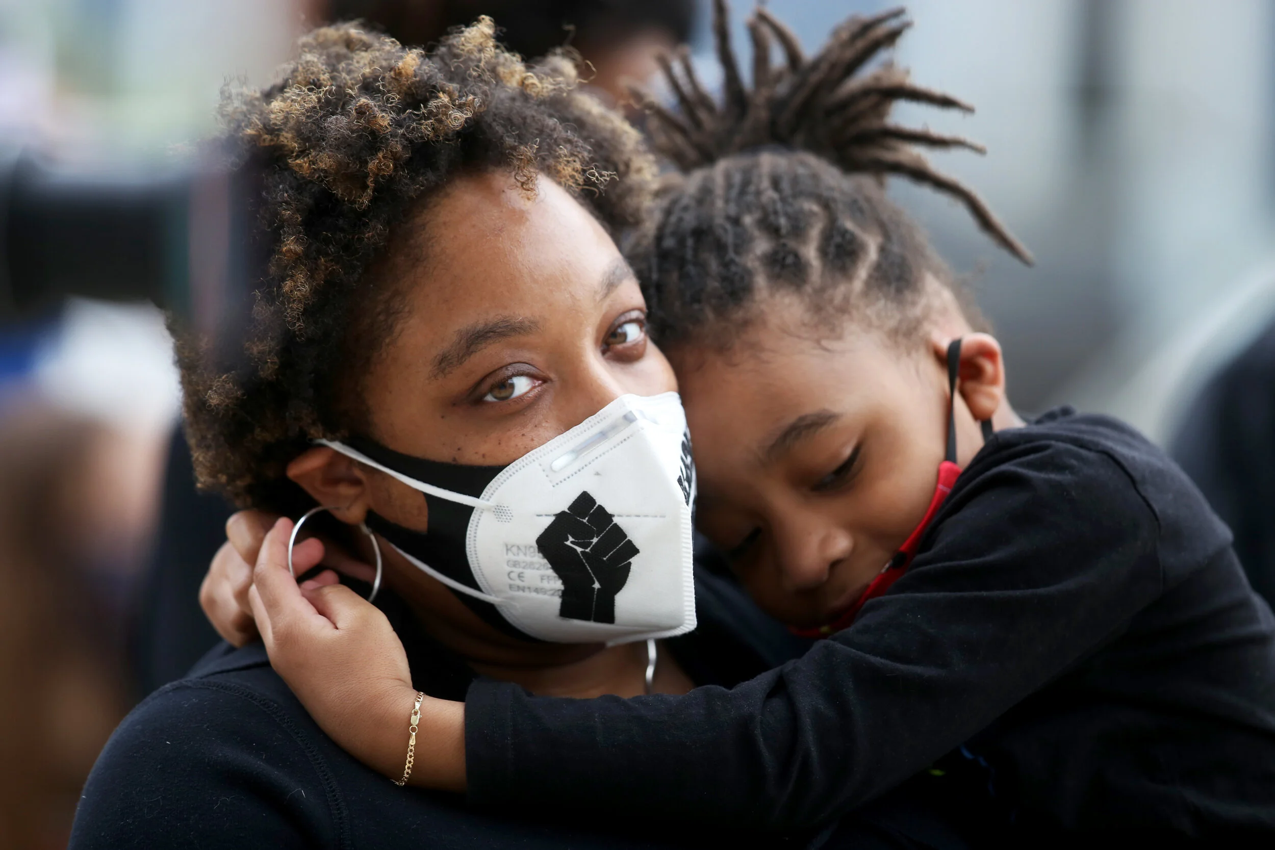 From left, Lynn residents Shaneeka Belmer-Quinerly and her son Roman, 4, listen to speakers at a Black Lives Matter protest on June 10.