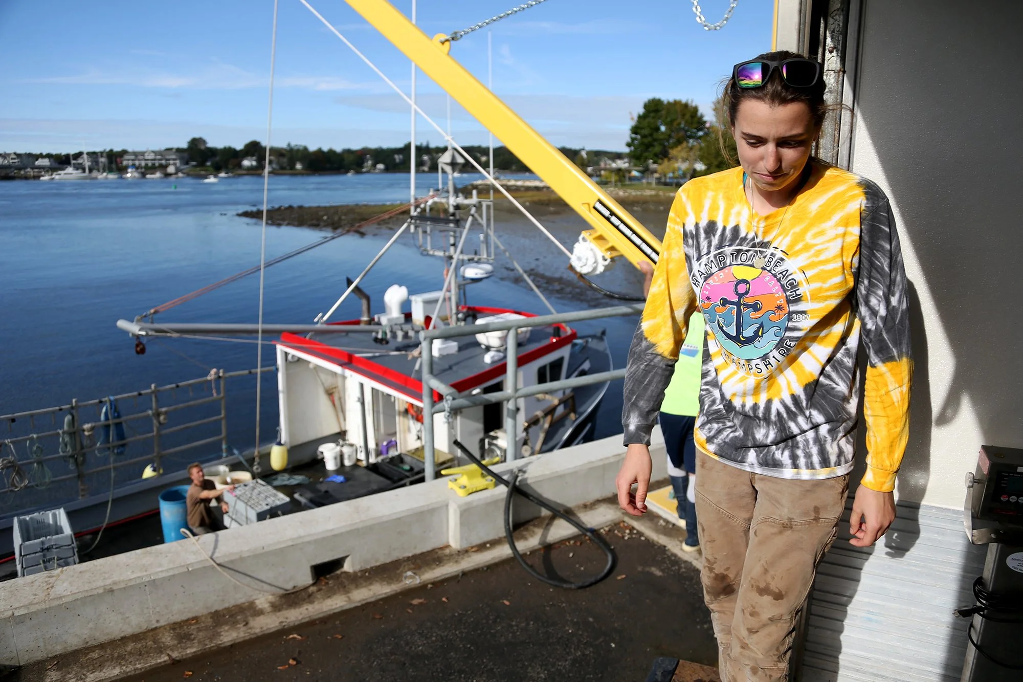 Jillian takes a break after loading crates of lobsters and crabs into her truck at the docks in Portsmouth on October 5, 2021.